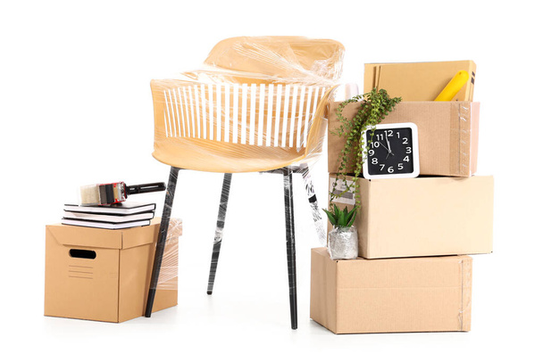 Cardboard boxes with office stuff and chair on white background - Photo, Image