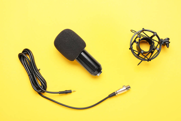 Modern microphone with stand on yellow background - Photo, Image