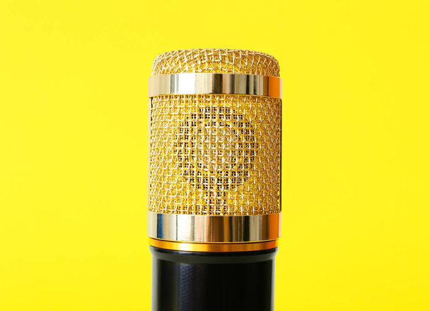 Modern microphone on yellow background, closeup - Zdjęcie, obraz