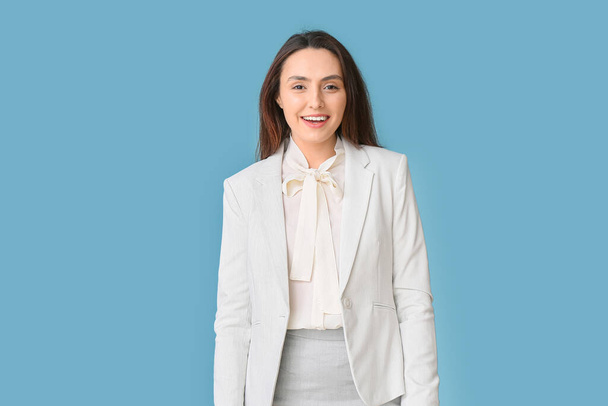 Portrait of young secretary on blue background - Фото, зображення