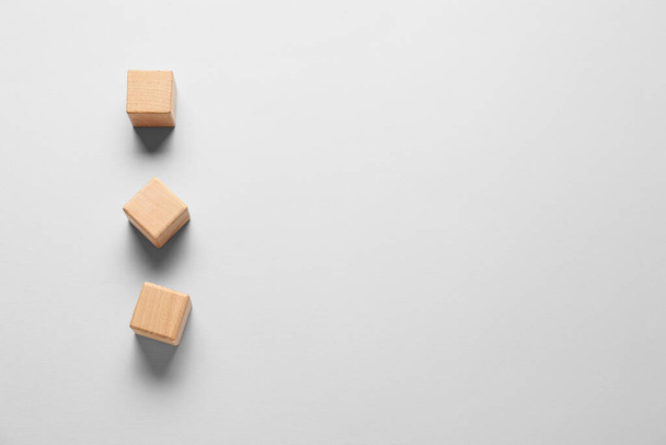 Wooden cubes on light background - Фото, изображение