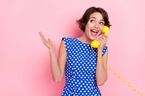 Photo of impressed young brunette lady talk telephone wear blue blouse isolated on pink color background - Photo, image