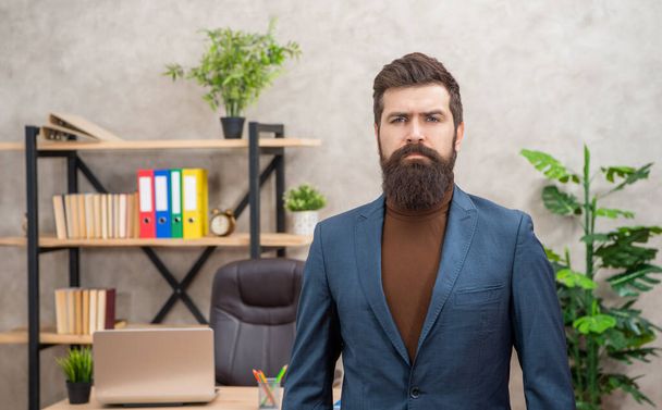 brutal serious lawyer in businesslike suit at office with copy space, businesslike - Foto, immagini