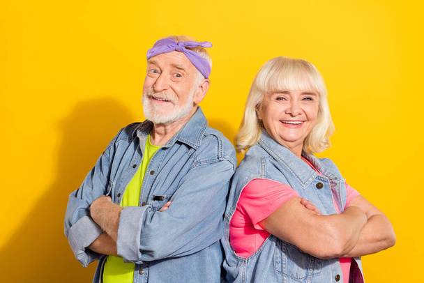 Photo of cute retired husband wife wear jeans clothes arms folded isolated yellow color background - 写真・画像