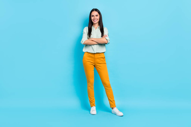 Full body photo of young cheerful woman crossed hands representative isolated over blue color background - Valokuva, kuva