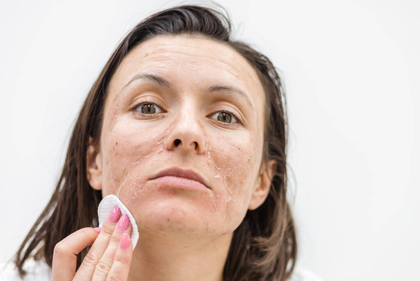 Close up photo of woman cleaning face with cosmetic sponge. - Foto, Bild