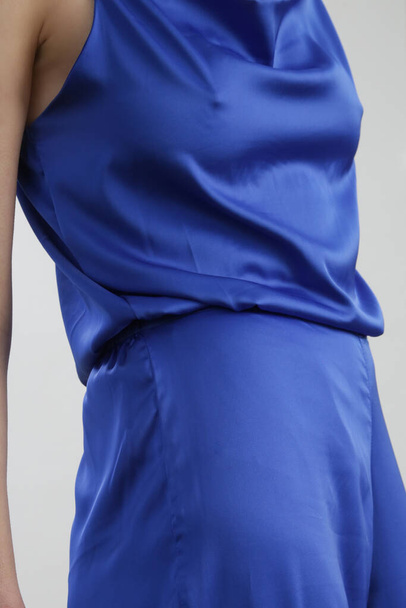 Woman in silk royal blue pants and camisole, studio shot. - Φωτογραφία, εικόνα