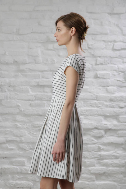 Studio shot of woman in striped cotton summer dress. - Foto, Imagem