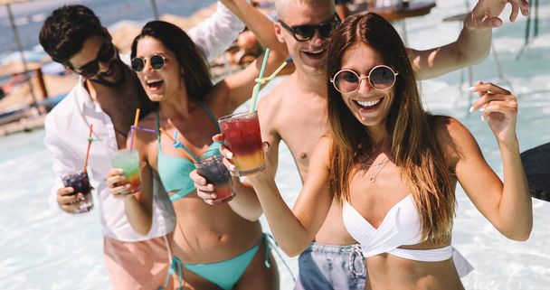 Group of happy friends having fun on tropical beach, summer holiday party - 写真・画像