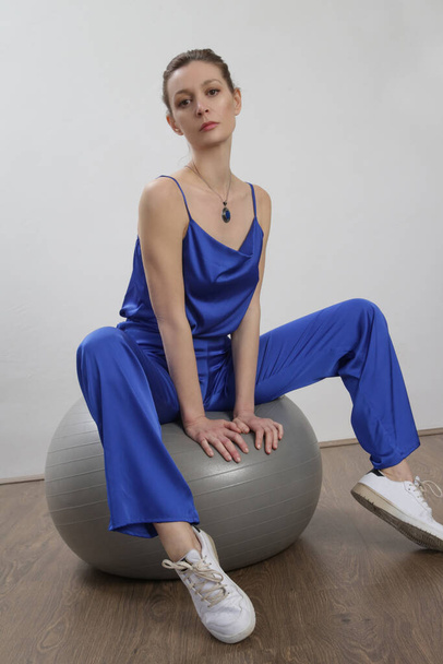 Woman in silk royal blue pants and camisole, studio shot. - Zdjęcie, obraz