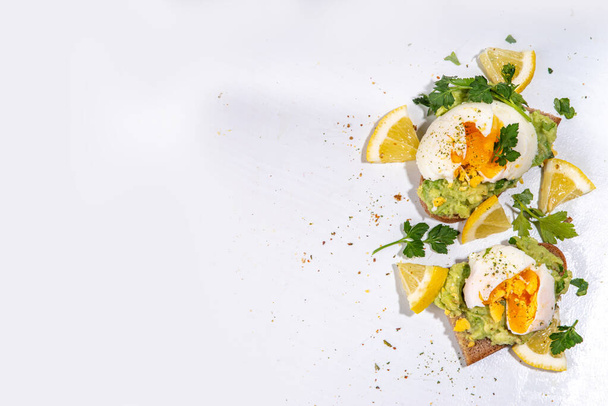 Healthy diet sandwiches for breakfast, snack. Toast with guacamole avocado salsa and poached egg  - Photo, Image