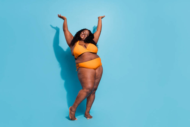 Full length photo of large oversize lady enjoy dance conscious love body raise hands up isolated over blue color background - Foto, Imagem