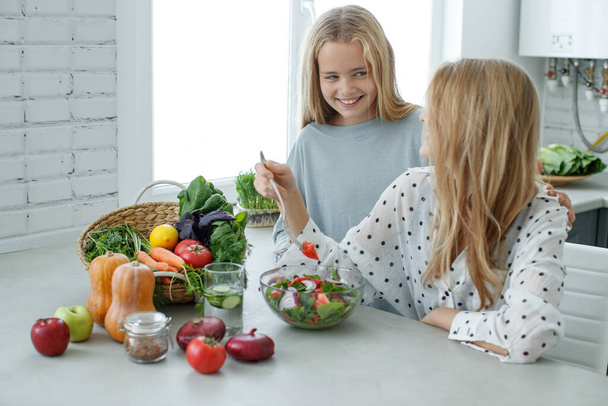 Healthy food woman. Girls girlfriend eats a salad. - Fotó, kép