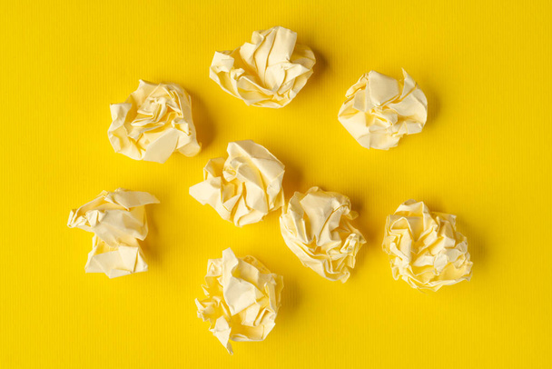 some crumpled pieces of paper on a yellow surface - Fotoğraf, Görsel