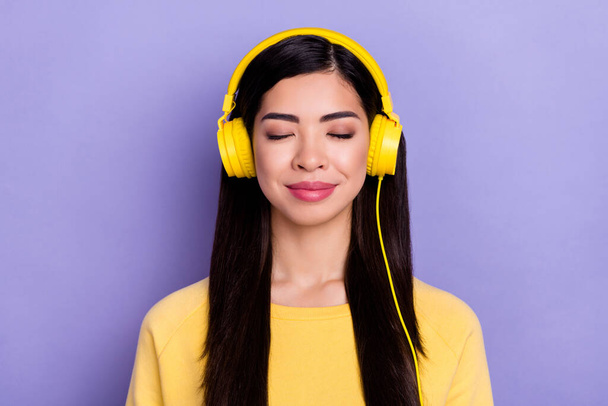 Photo of young charming girl dreamy enjoy radio headphones meloman isolated over purple color background - Foto, Imagem