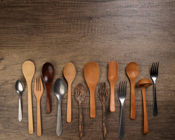 Varity dřevěné kovové lžíce kuchyňské nádobí na rustikálním dřevě pozadí kopírovat text prostor - Fotografie, Obrázek