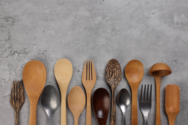 Varity of wooden metal plastic spoon kitchen tableware on rustic background copy text space - 写真・画像