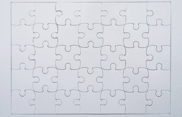 Closeup of white puzzle background. - Foto, afbeelding