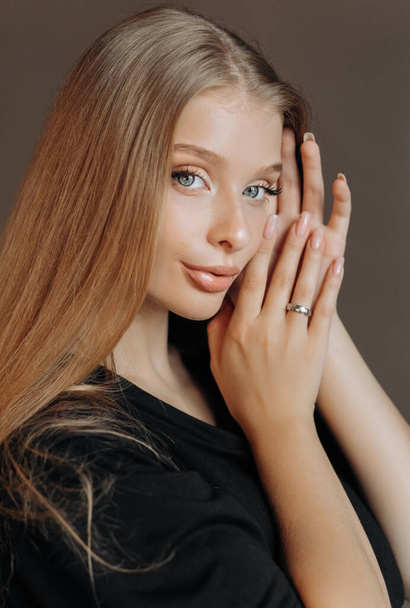 Close-up portrait of a blonde. Clean skin, natural makeup, blue eyes. - Photo, Image