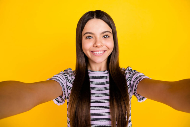 Photo of young pretty girl shoot selfie travel trip influencer isolated over yellow color background - 写真・画像