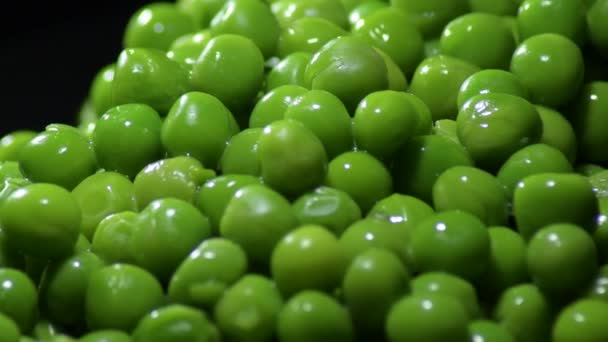 Fresh green peas on black background gyrating - Footage, Video
