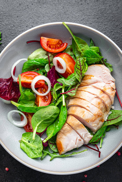 salad chicken breast vegetable tomato, onion, green mix leaves lettuce fresh meal food snack on the table copy space food background  - Photo, Image