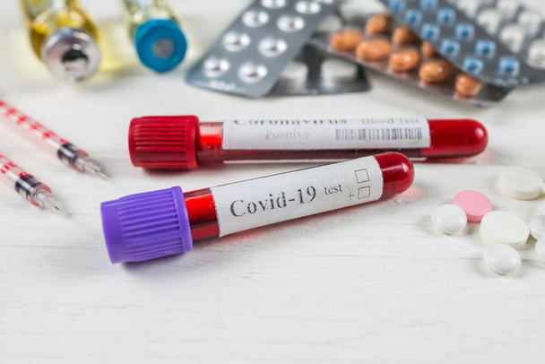 test tube with blood for 2019-nCoV analysis, different pills. New concept of blood test for Chinese coronavirus. - Photo, image