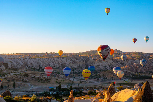 Cappadocia and hot air balloons in the morning. Travel to Goreme background. Nevsehir Turkey - 7.1.2021 - Fotó, kép