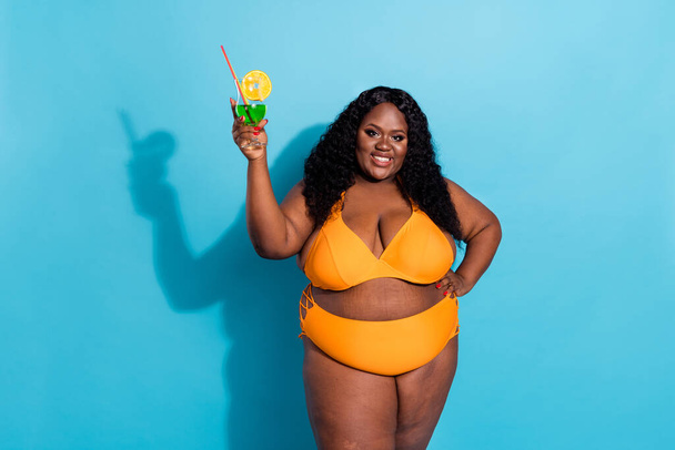 Photo of chubby curvy trendy lady enjoy relax hold green lemonade isolated over blue color background - Fotografie, Obrázek