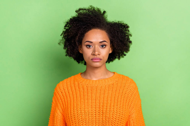 Photo of strict young volume hairdo lady wear orange sweater isolated on green color background - Foto, immagini