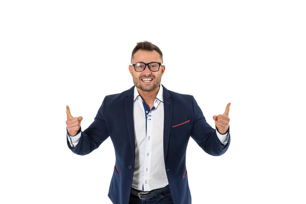 Successful business man in glasses points up with his fingers, isolated on white. - Foto, imagen