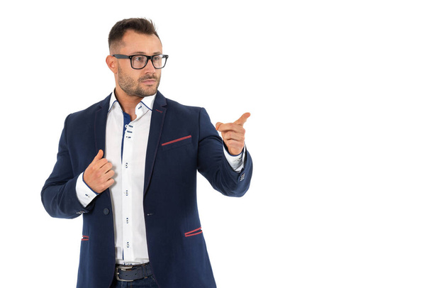 Serious business man in glasses looks and points fingers to the side, object isolated on white. - Foto, imagen
