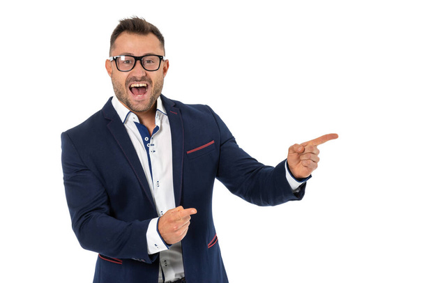Happy business man in glasses points his finger to the right, isolated on white. - Foto, imagen