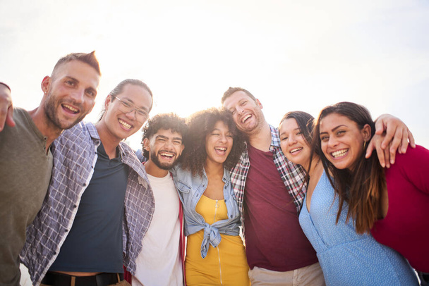 Happy group of friends taking smiling selfie outdoors. Friendship concept on young people enjoying time together and having fun. - Photo, Image
