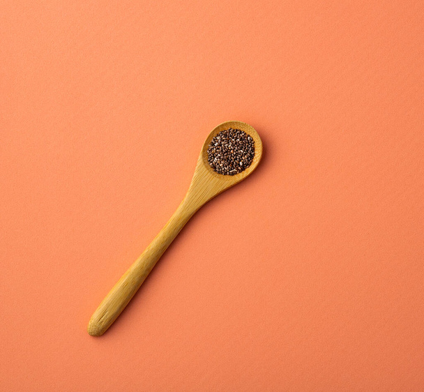 Organic chia seeds in the wooden spoon - Salvia hispanica - Fotoğraf, Görsel