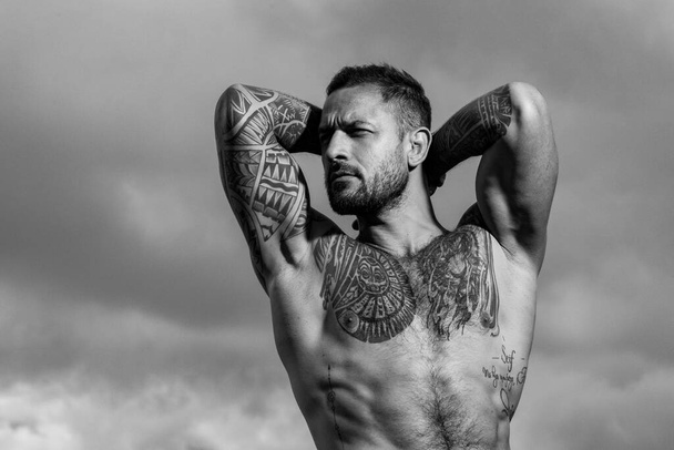 Sexy man with naked torso. Portrait of handsome man with serious face. Strong muscular male body, muscles guy. Naked male shoulders, topless athletic body. - 写真・画像