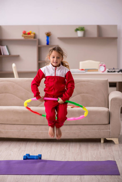 Young little girl doing sport exercises at home - Photo, Image