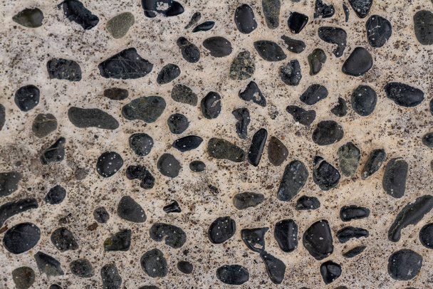 The arrangement of gravel mixed with cement used for pavement corridors in the garden, creates the impression of returning to nature, for a background with a nature theme - Photo, Image