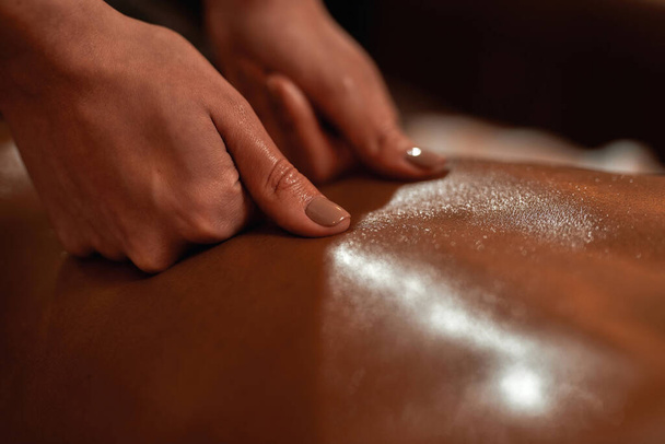 Close up of masseur doing back massage of woman - Fotó, kép