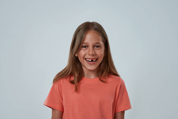 Portrait of pleased little girl looking at camera - Фото, зображення