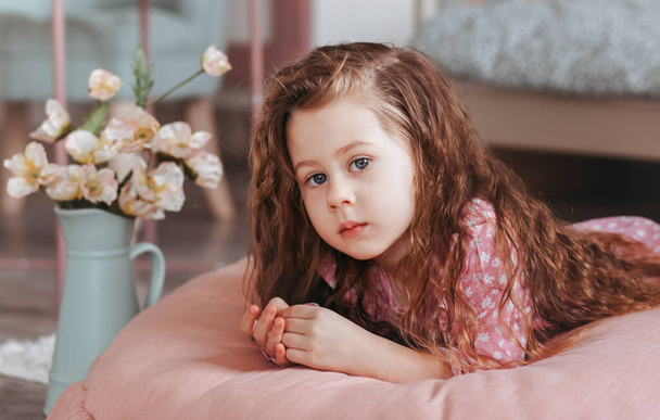 Close up lonely little girl in bedroom with toys, stay at home alone, upset unhappy child waiting for parents - Photo, Image