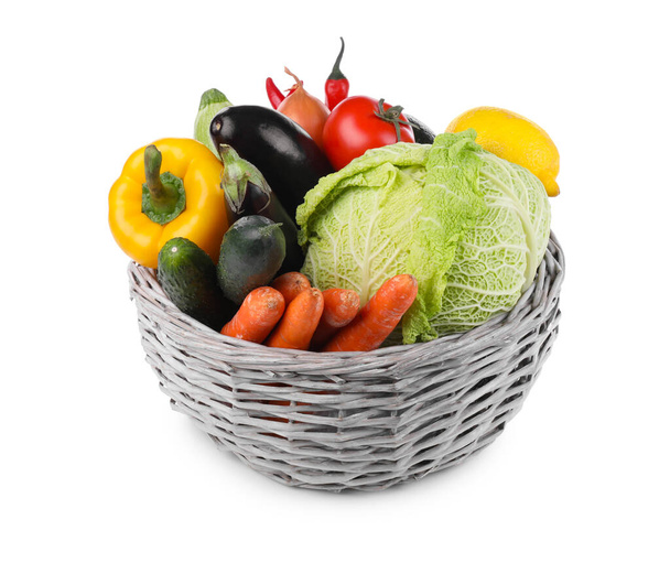 Wicker basket with fresh ripe vegetables and fruit on white background - Foto, imagen