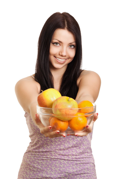 Happy woman holding a dish with fruits on white background - Φωτογραφία, εικόνα