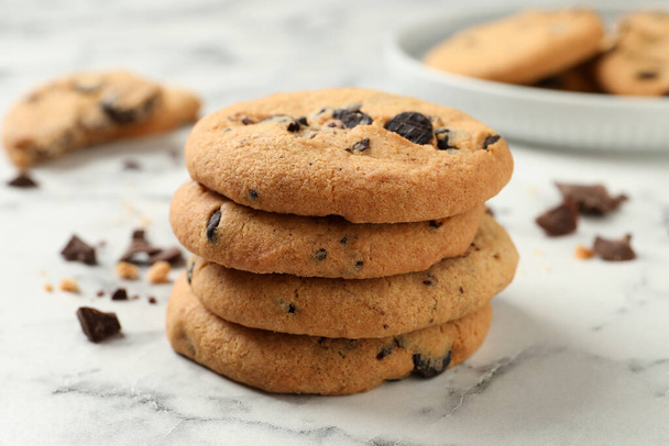 Delicious chocolate chip cookies on white marble table - Photo, image