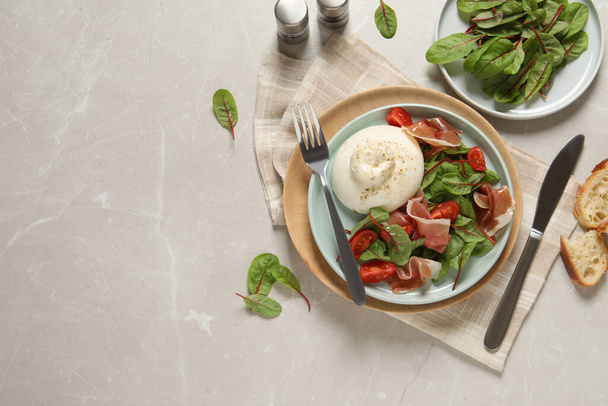 Delicious burrata salad served on light grey marble table, flat lay. Space for text - Φωτογραφία, εικόνα