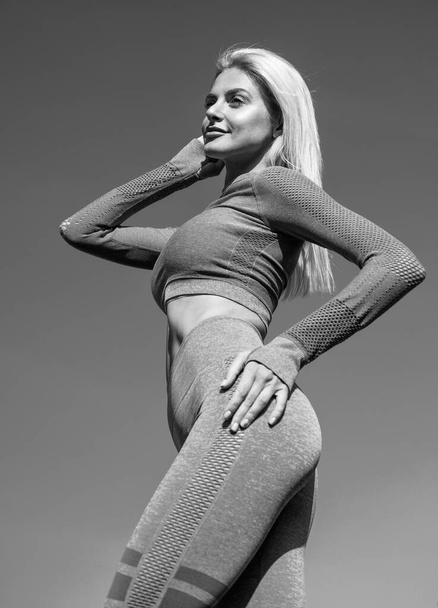 athletic woman in fitness wear has fit body pose outdoor, fitness - Φωτογραφία, εικόνα