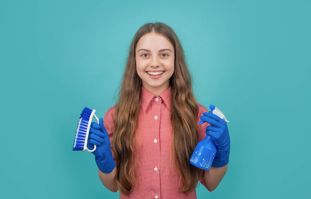 cheerful child in rubber gloves with spray bottle and brush on blue background - Φωτογραφία, εικόνα