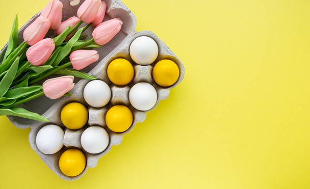 colors painted yellow easter eggs on yellow background - 写真・画像