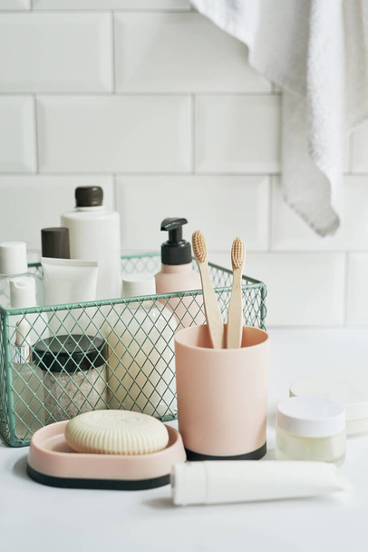 Bath accessories. Dressing table. Cosmetics and hygiene products. Spa and beauty salon. Toothbrush and soap, cream containers. - Foto, Imagem
