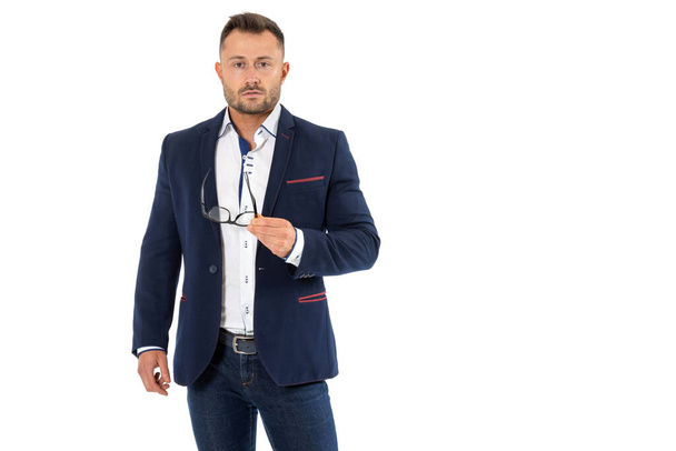 Business man in a jacket take off his glasses and looking at camera, isolated on a white background. - Фото, изображение